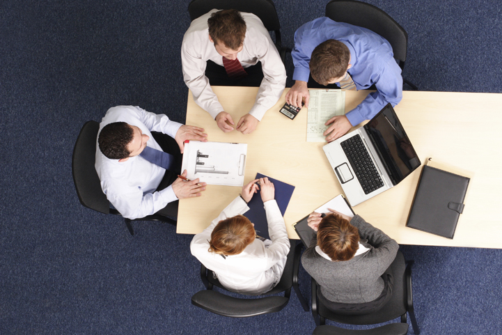 overhead view of office workers at a conference table