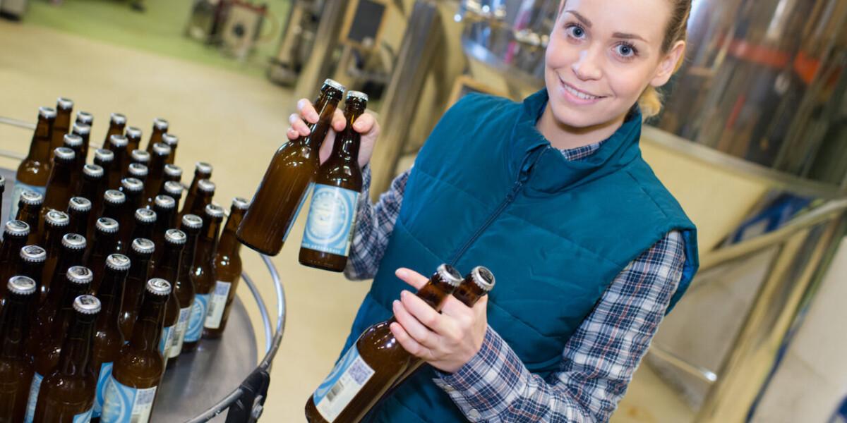 female worker in a craft beer bottling facility