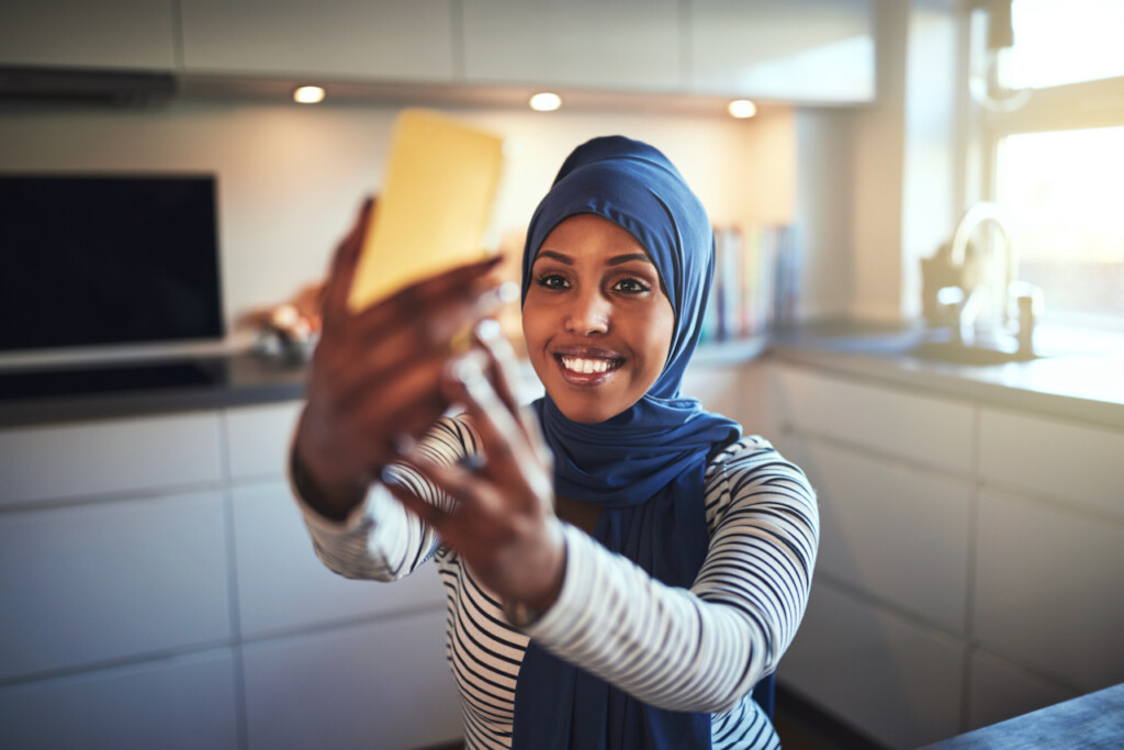 summer academy precollege student taking photograph in kitchen
