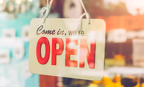 Small business open sign hanging in a door.