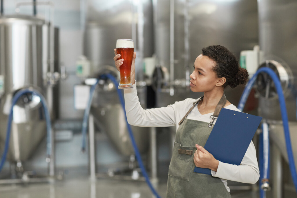 business of craft beer woman looking at beer in glass