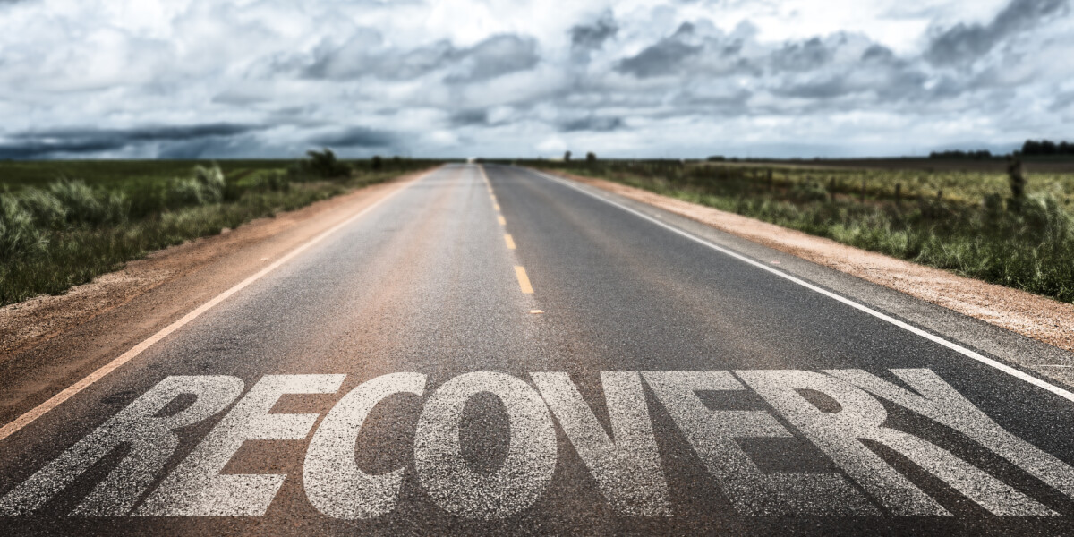 Recovery written on a road