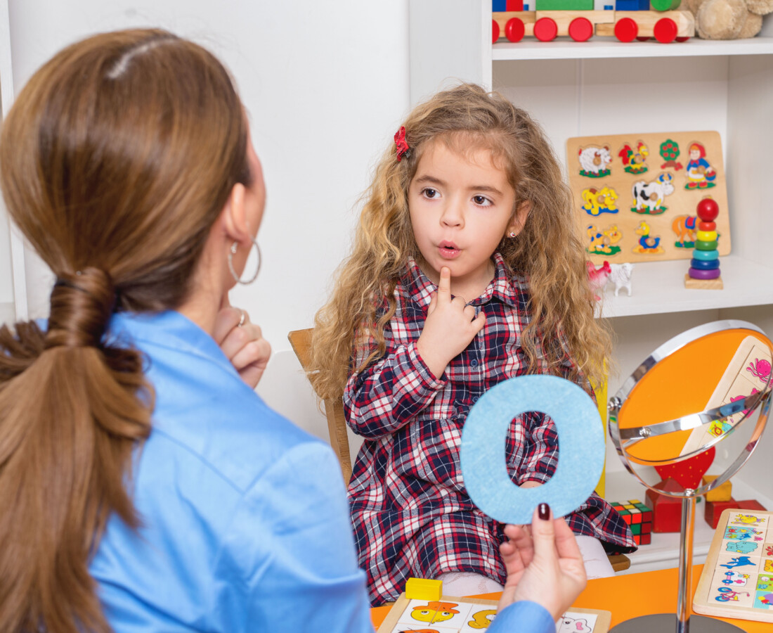 young girl and therapist doing speech therapy