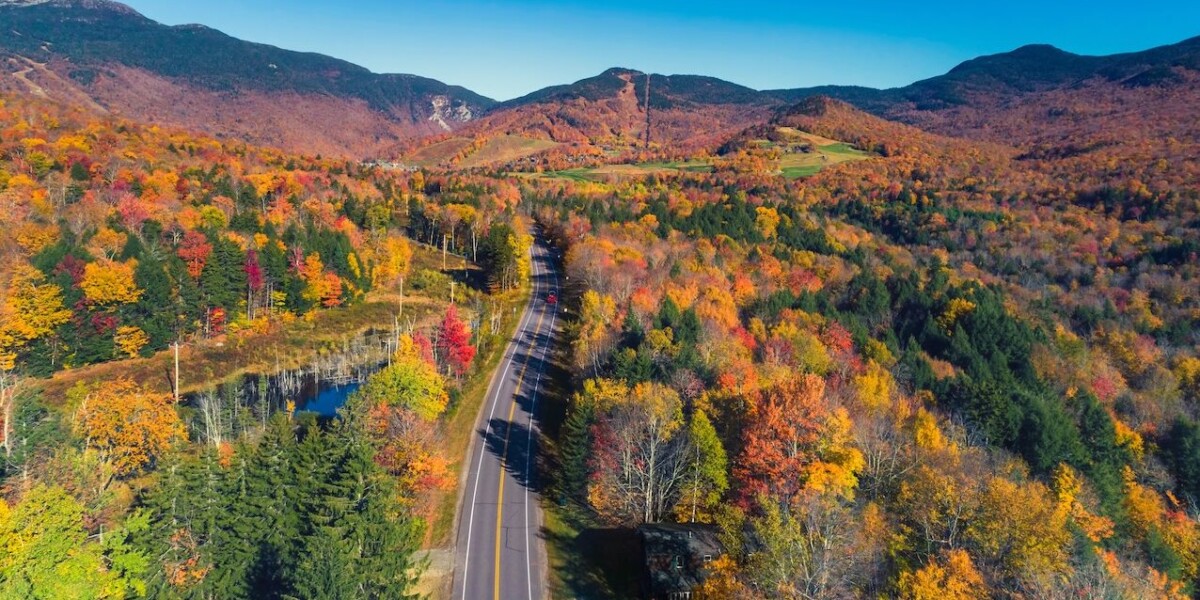 Road leading to ski resort in Stowe, Vermont. Aerial view with fall scenery