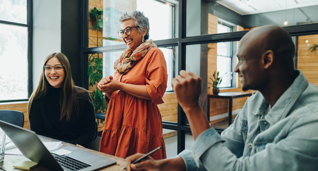 Diverse business people smiling cheerfully during an office meeting