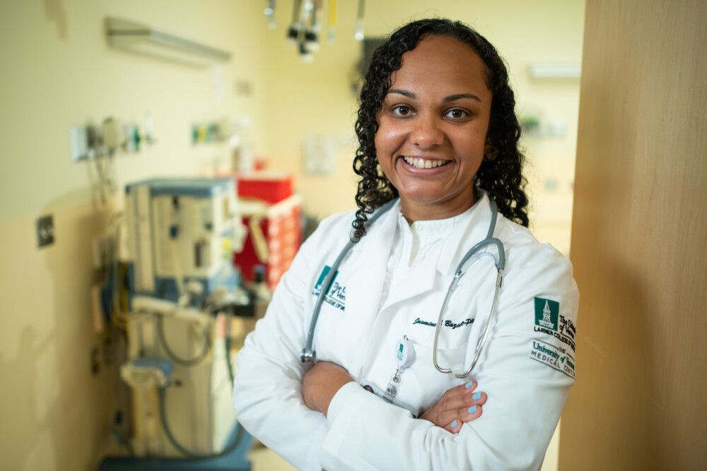 post bacc pre med student jasmine smiling wearing white coat