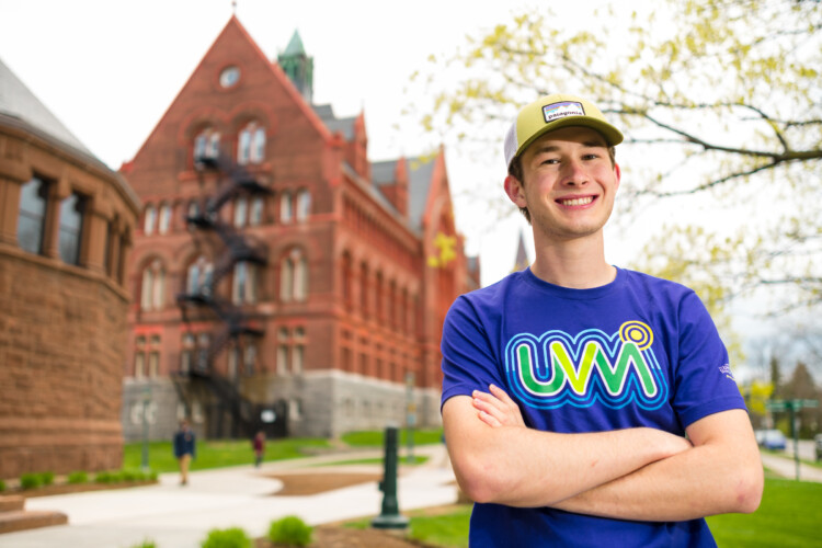 UVM student smiling on campus outside of Williams Building