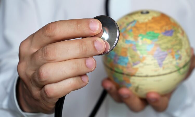doctor with stethoscope and globe for global health