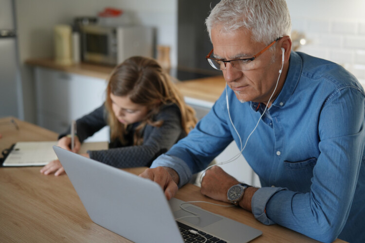 Father and school-girl working form home, telework and e-learning