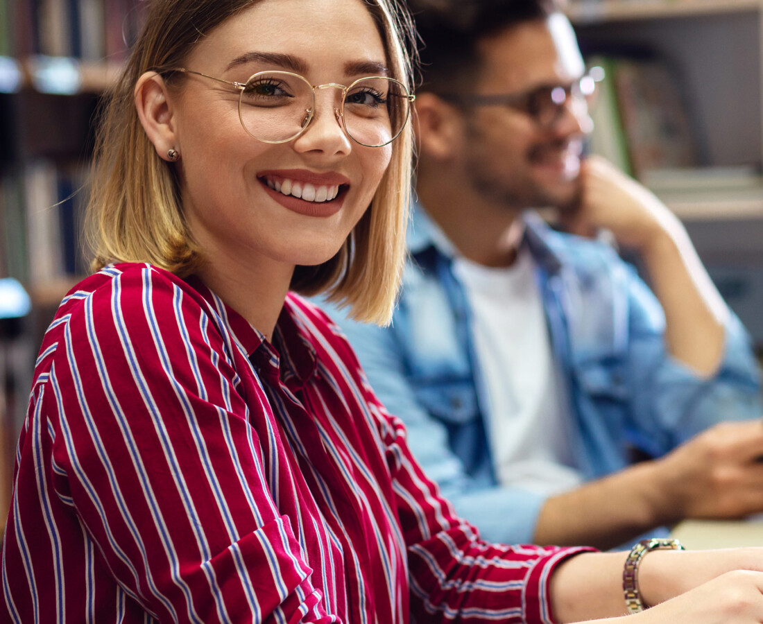 Person sitting wearing a red striped shirt