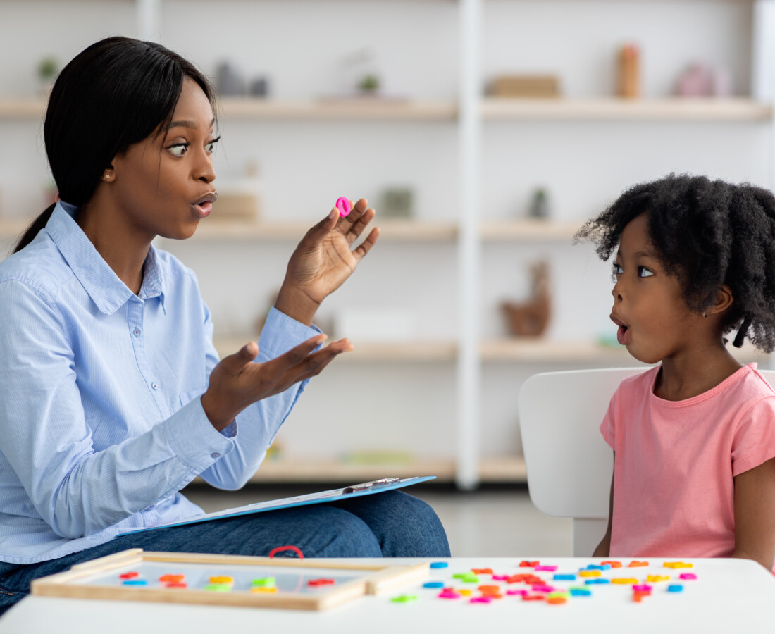 Speech therapist working with little girl