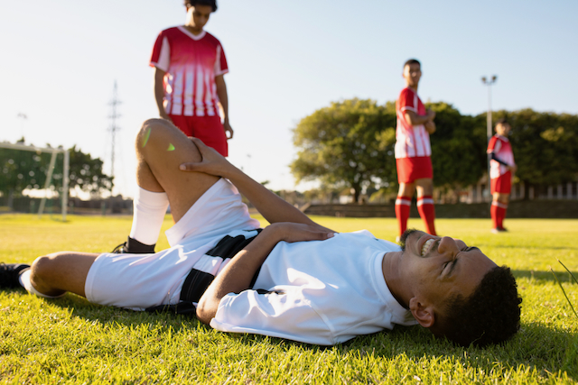 injured soccer playing on field