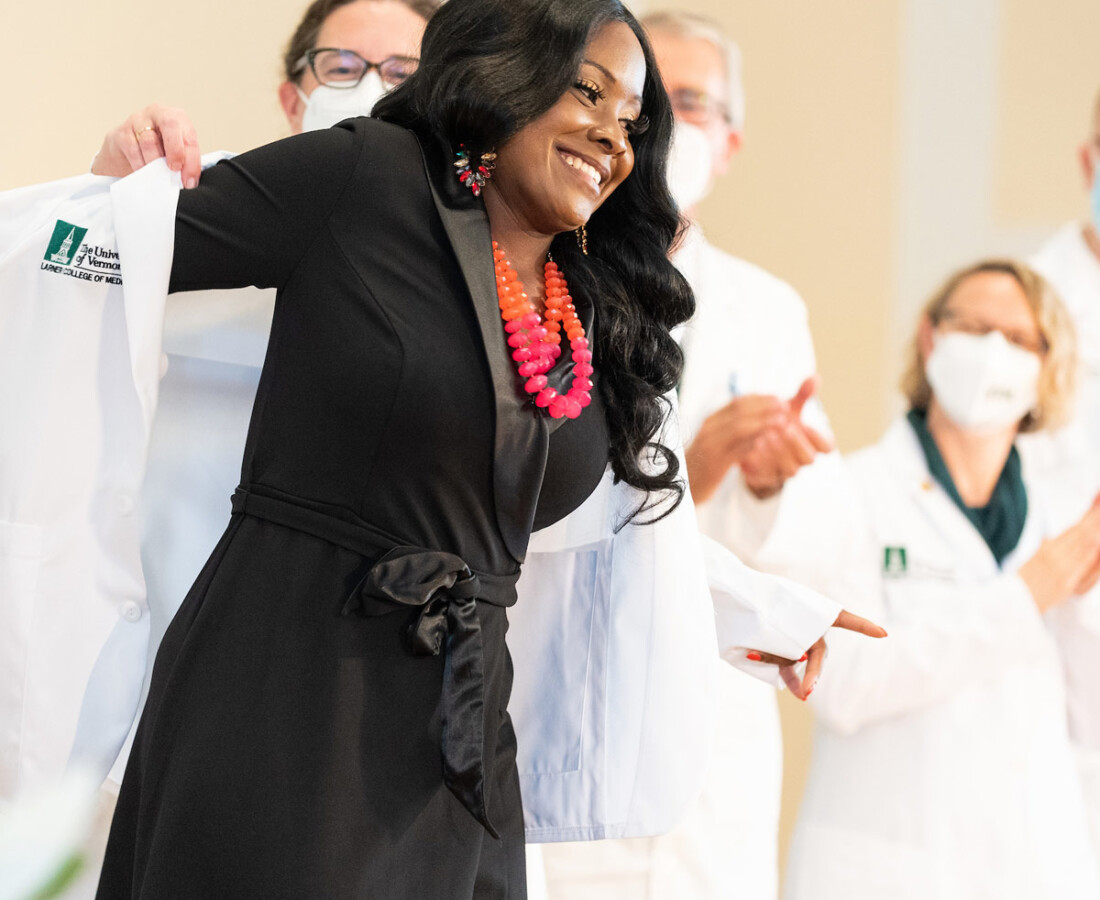 Woman graduating receiving a white coat