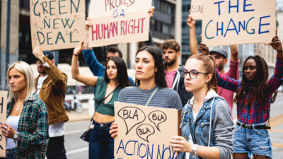 Group of students protesting climate change on college campus.