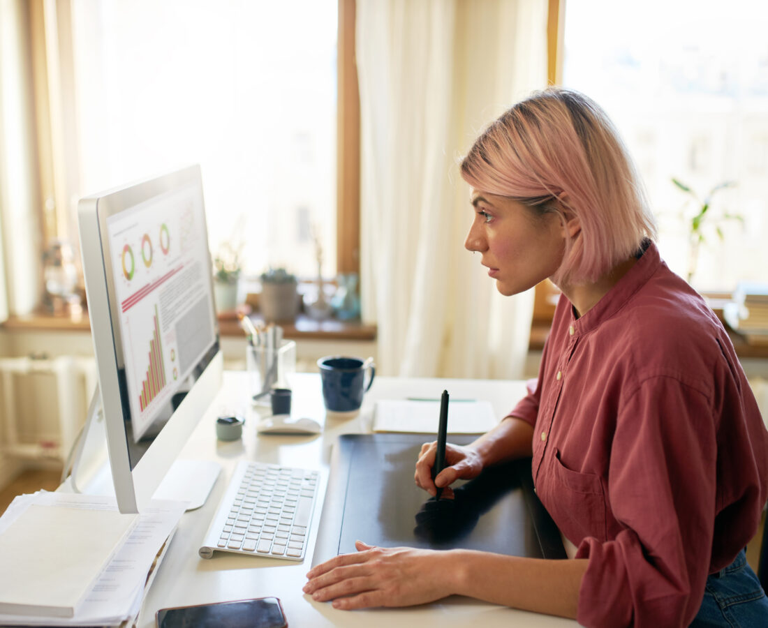 Person working at a desk staring at a computer screen