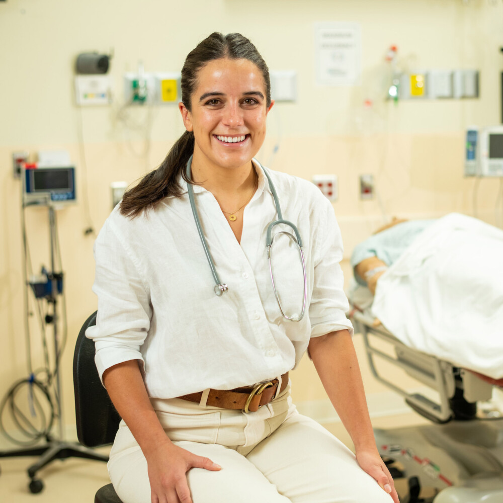 Student in a medical setting wearing a stethoscope