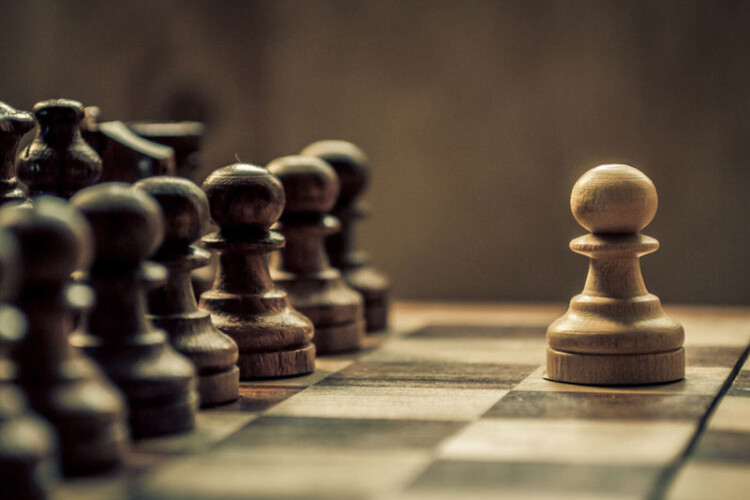 Chess board with a pawn standing alone