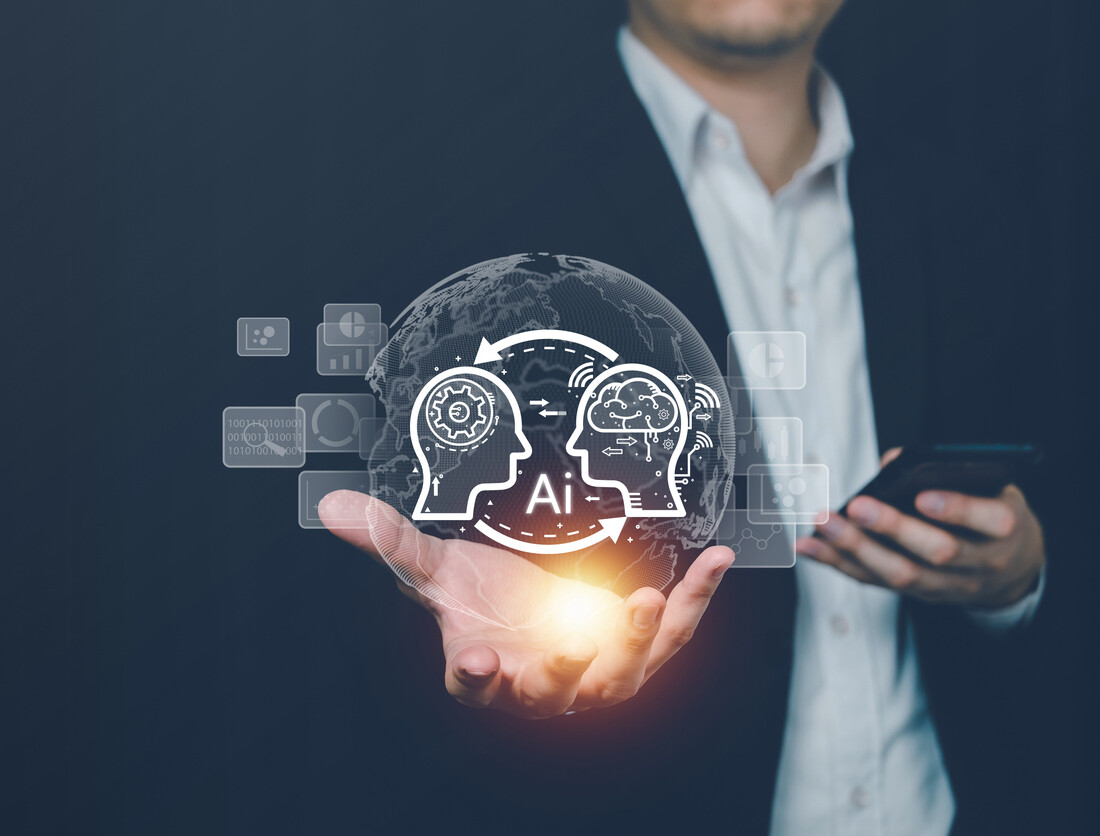 AI technology graphic showing a person in a suit jacket with no tie holding a bright sphere in their hand