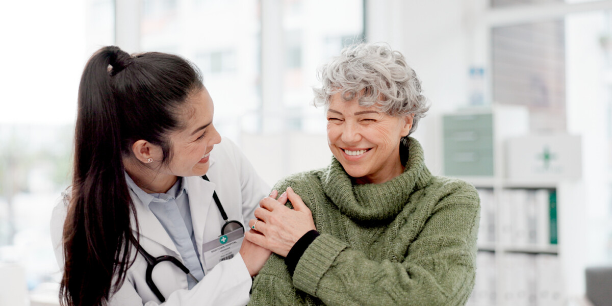 Doctor with a person for medical healthcare consultation at a clinic