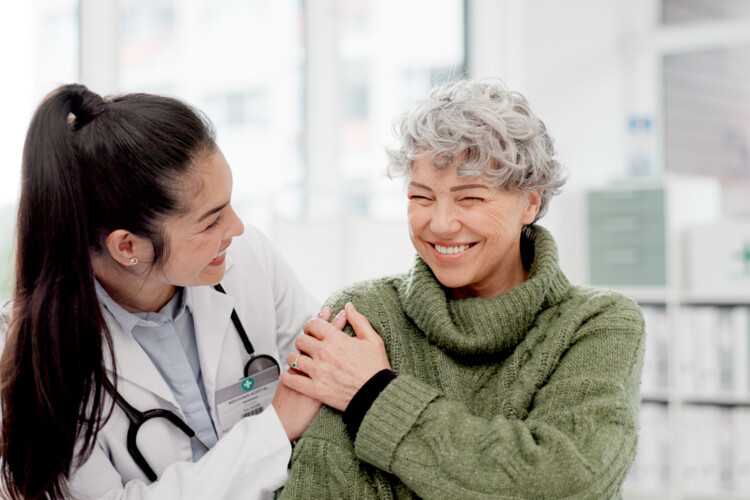 Doctor with a person for medical healthcare consultation at a clinic