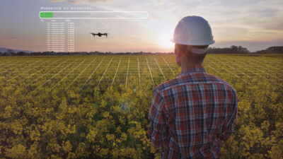 Intro to UAS and Geospatial Applications. Engineer using an Agritech drone to scan agricultural fields with 2D graphics.