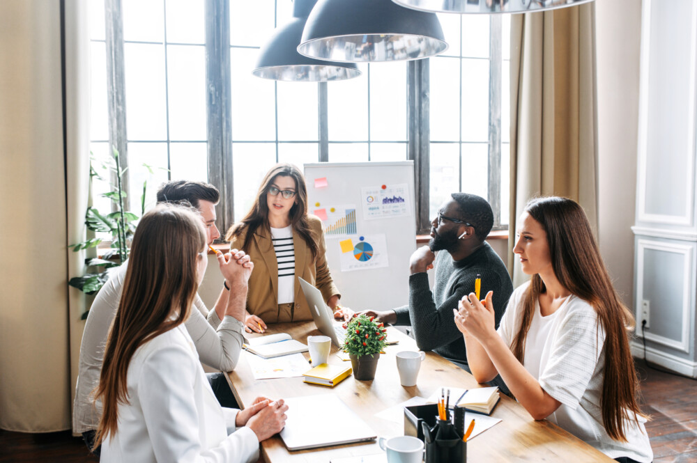 Strategic leadership group working around a table in an office conference room.