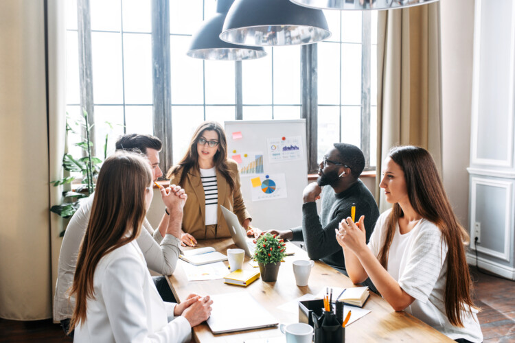 Strategic leadership group working around a table in an office conference room.