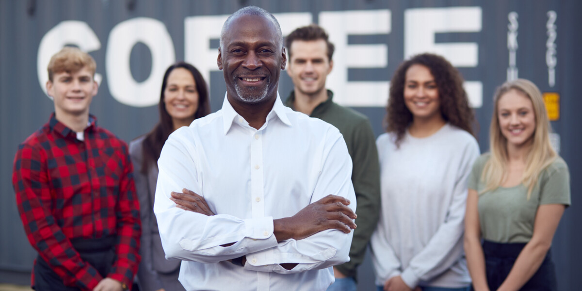 team of entrepreneurs with leader standing in front of group