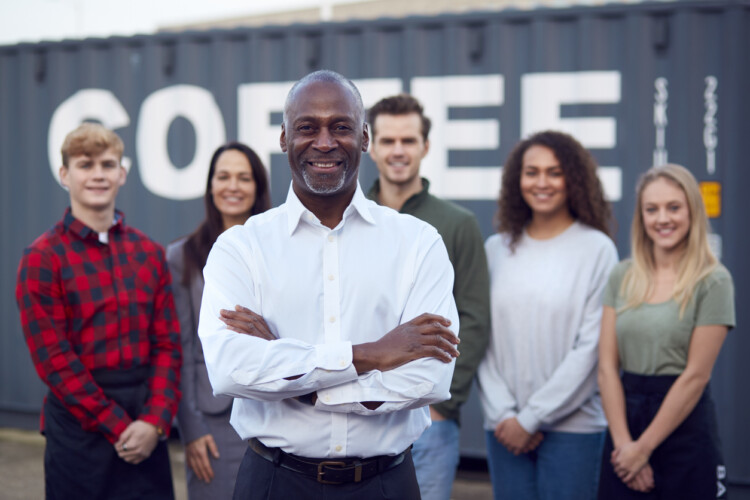 team of entrepreneurs with leader standing in front of group