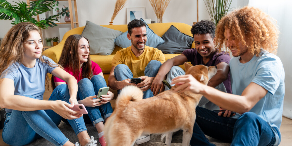 Pet Loss Support Group Specialist sitting with group of people with a pet dog getting attention.