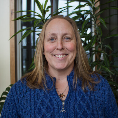 Dorothy Horn wearing a blue shirt posing for a headshot looking directly at the camera