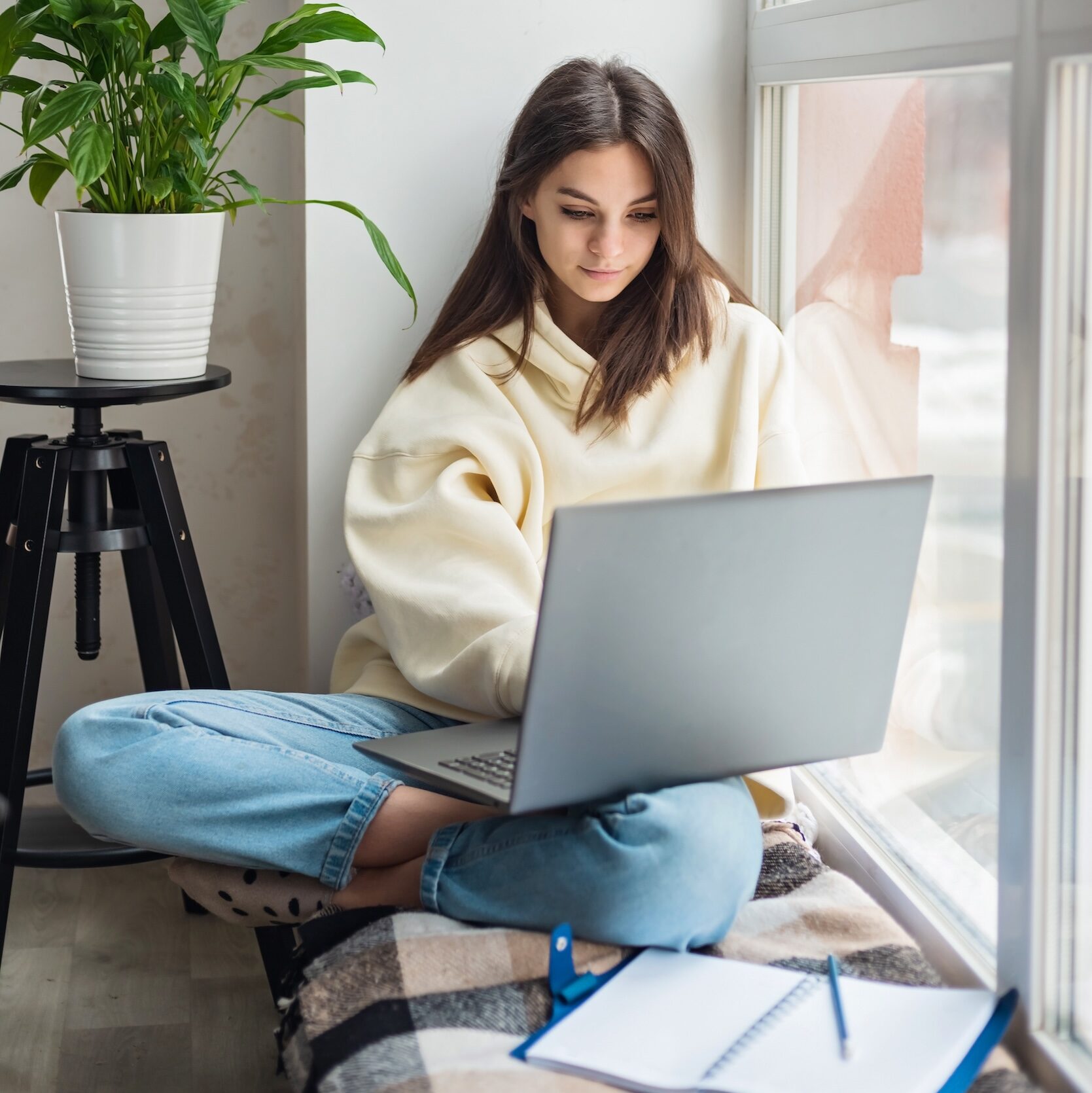 High school student working on a laptop while online learning for a University of Vermont class.