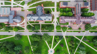 Drone view over University of Vermont campus showing buildings, sidewalks, and street. For Remote Sensing course.