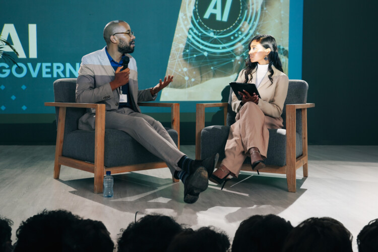 Event presentation and people with mic at stage for innovation speech or future development IT seminar and woman with man in conversation for ai governance machine learning or ethical guidelines
