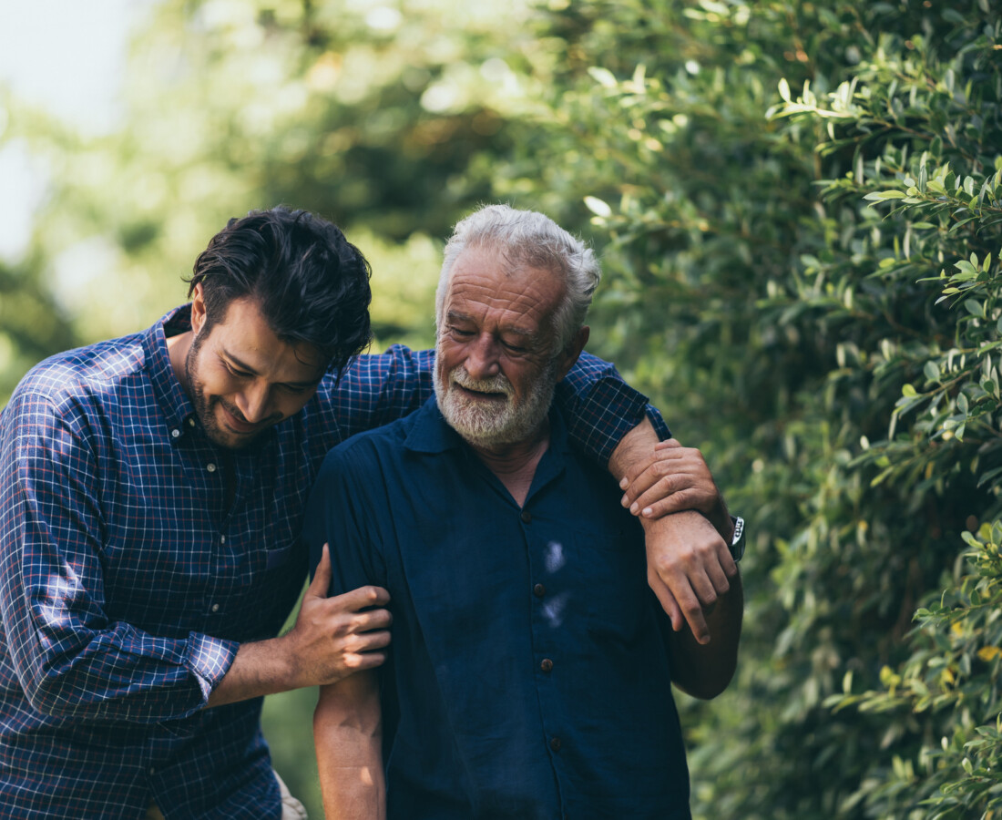A man hugs his elderly father