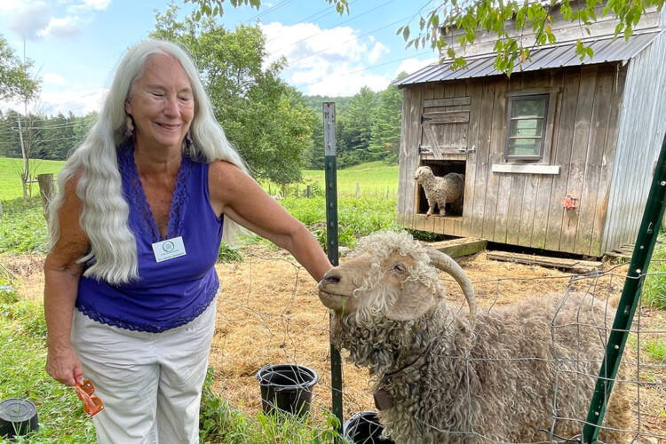 Dawn standing with a with goat