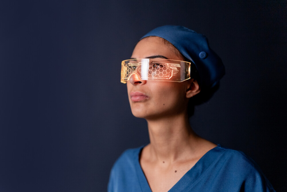 Young worker wearing futuristic augmented reality glasses on a black background