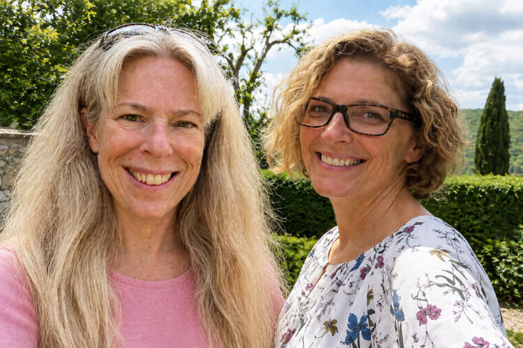 The OLLI team smiling in the sun in a garden setting